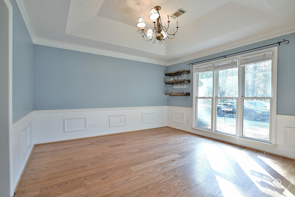 8935 K Moore Road Columbus, GA 31904 - Photo 4 of 36 a view of an empty room with a window and wooden floor