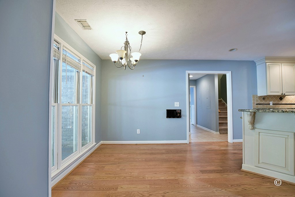 8935 K Moore Road Columbus, GA 31904 - Photo 7 of 36 wooden floor in an empty room with a window