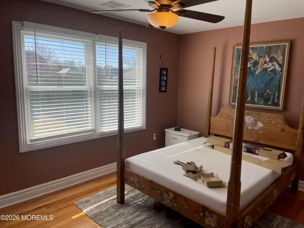 a bed sitting in a bedroom next to a window