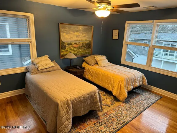 a bedroom with two beds and a window