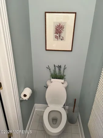 a white toilet sitting next to a small shower