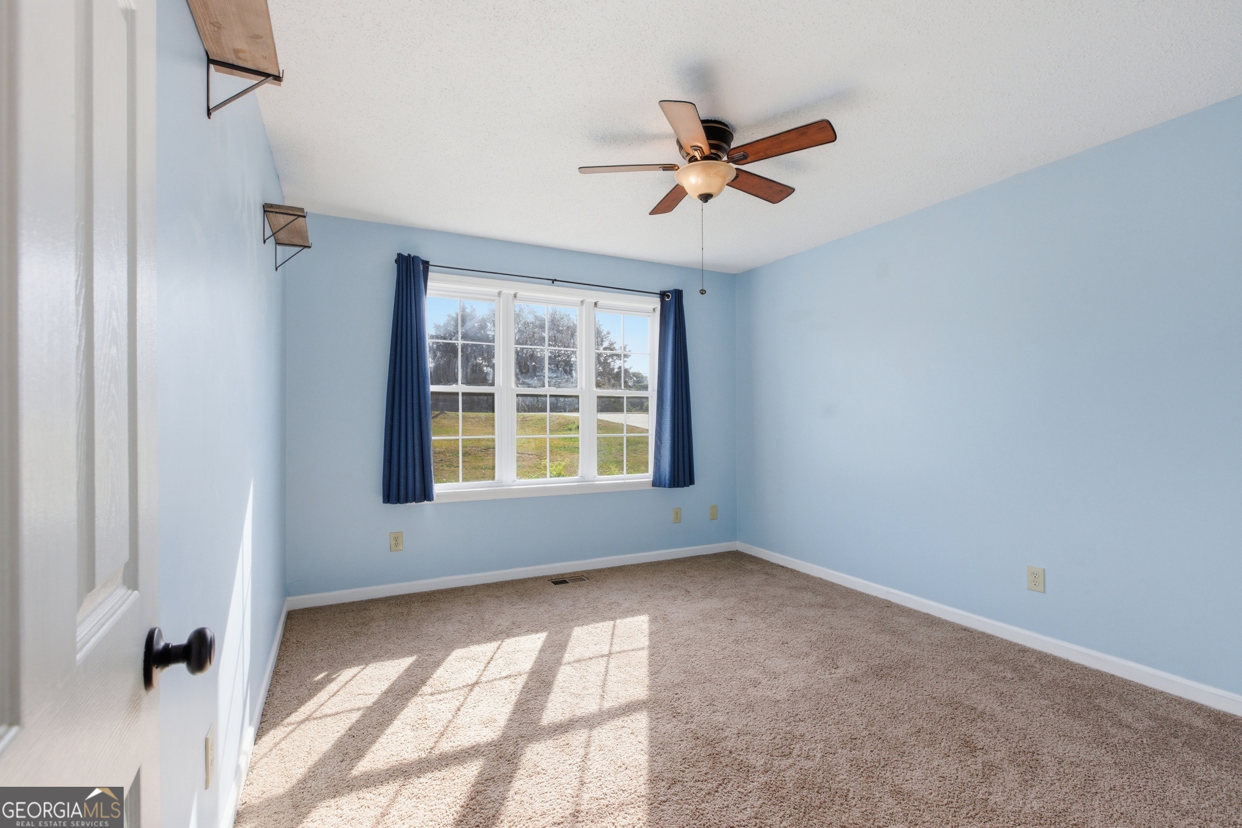 260 Brookhaven Circle Toccoa, GA 30577 - Photo 15 of 26 a view of a livingroom with a ceiling fan and window