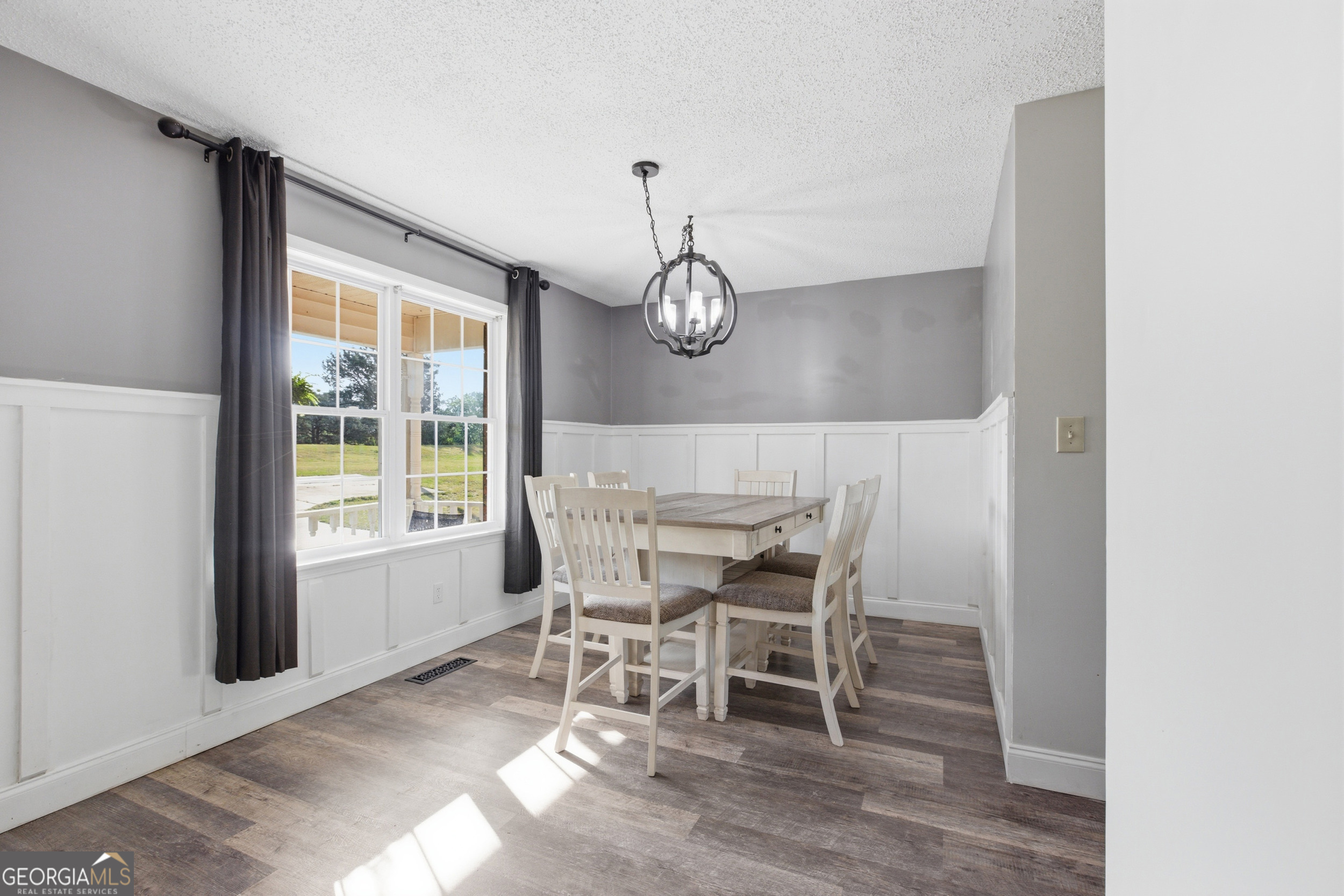 260 Brookhaven Circle Toccoa, GA 30577 - Photo 5 of 26 a dining room with wooden floor a chandelier a wooden table and chairs