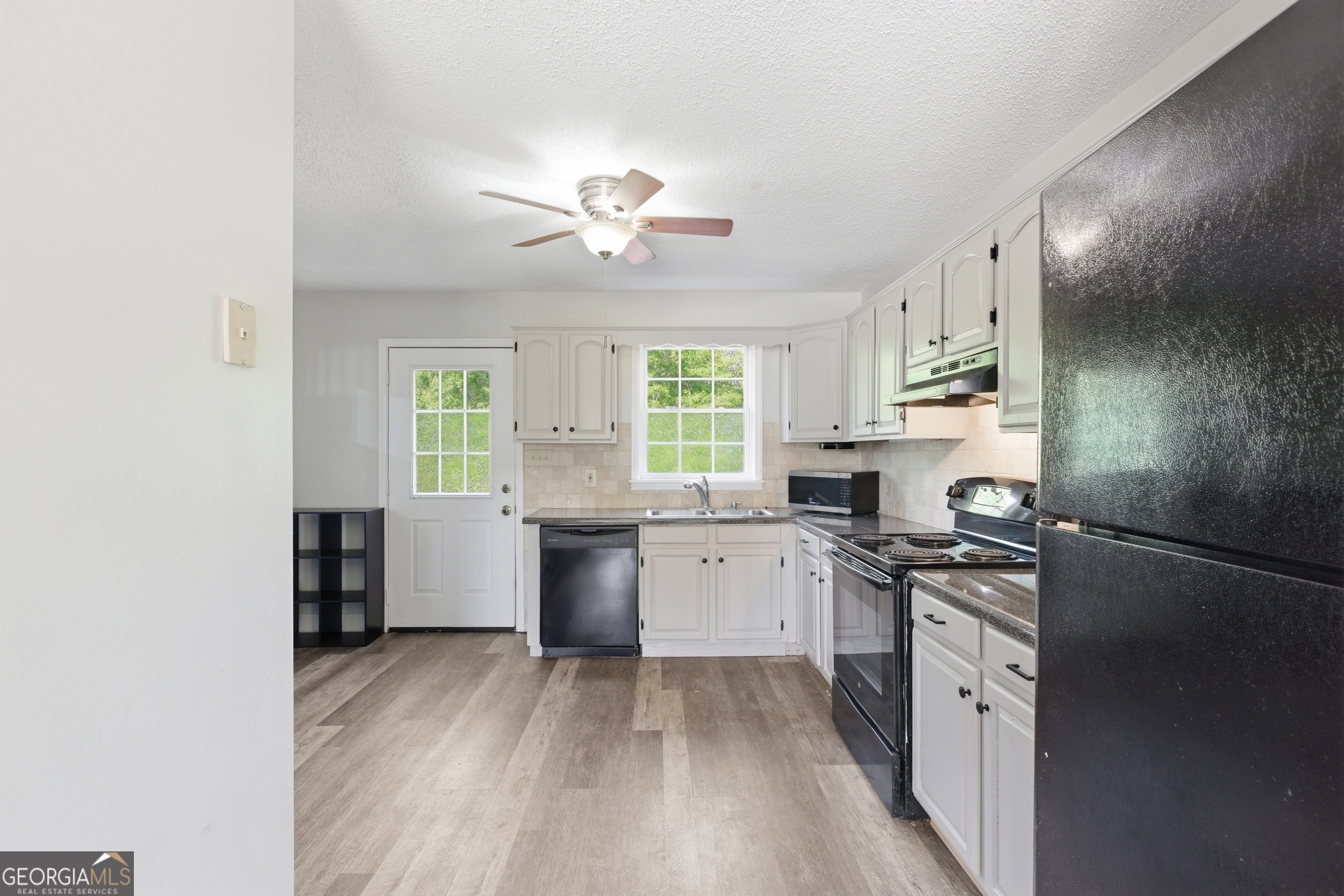 260 Brookhaven Circle Toccoa, GA 30577 - Photo 6 of 26 a kitchen with granite countertop a stove top oven sink and cabinets