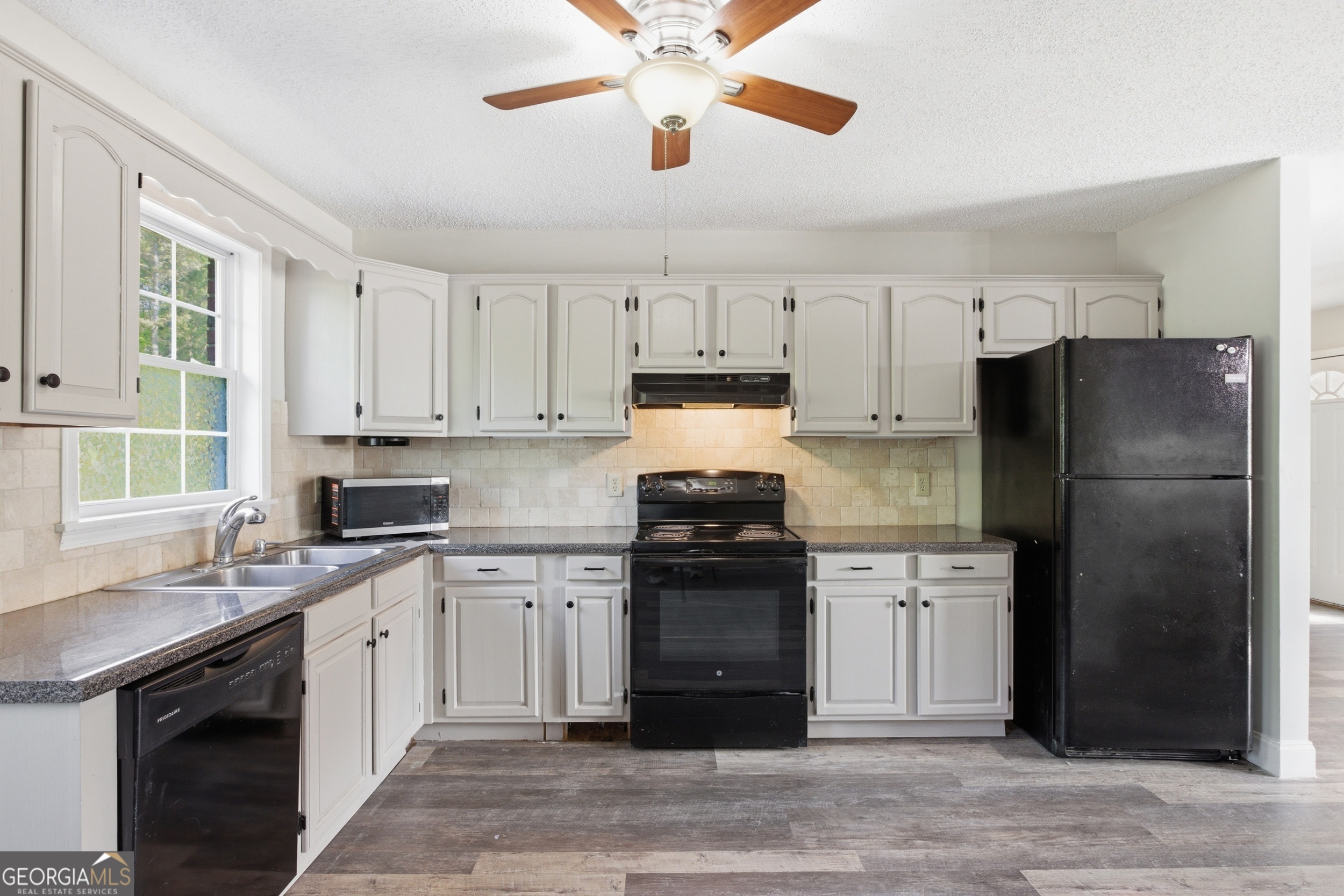 260 Brookhaven Circle Toccoa, GA 30577 - Photo 7 of 26 a kitchen with cabinets stainless steel appliances and a window