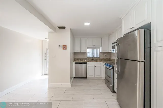 a kitchen with a refrigerator sink and stove