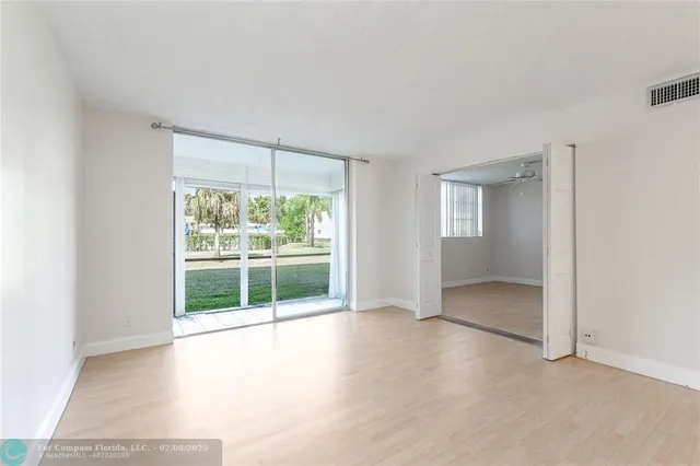 an empty room with large windows