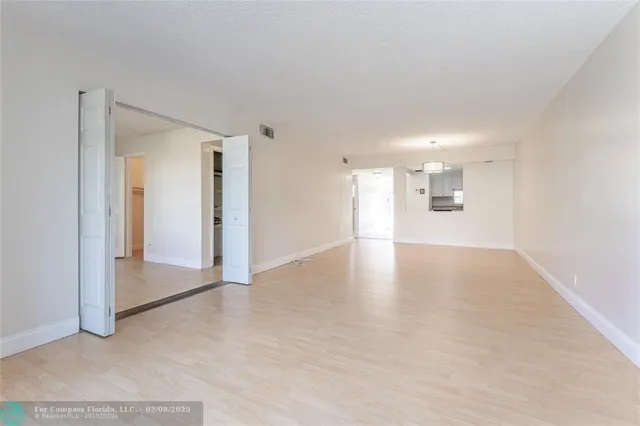 a view of a livingroom with wooden floor and a window
