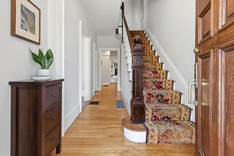 a living room with furniture potted plant and window