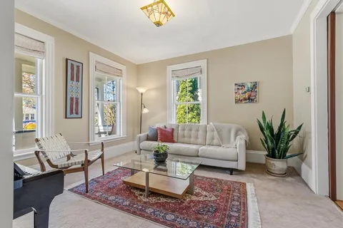 a living room with furniture rug and window