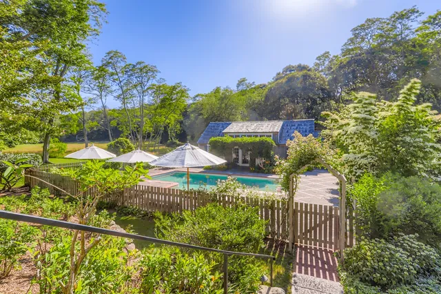 a kitchen with kitchen island granite countertop a sink stove and cabinets