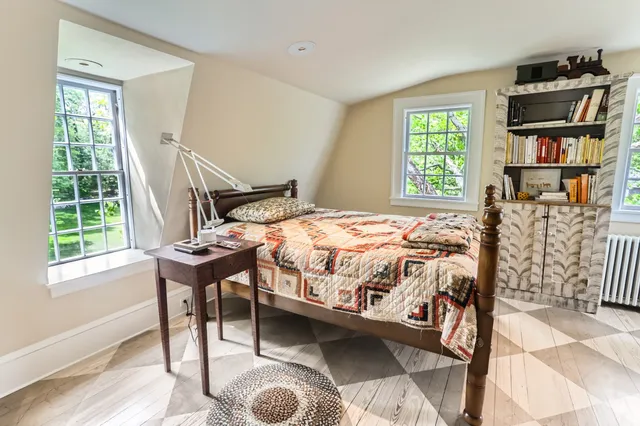 a living room with furniture a large window and a chandelier