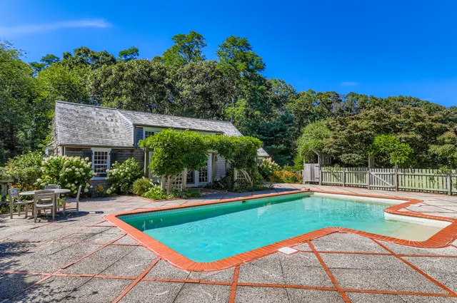 a living room with lots of furniture and a book shelf