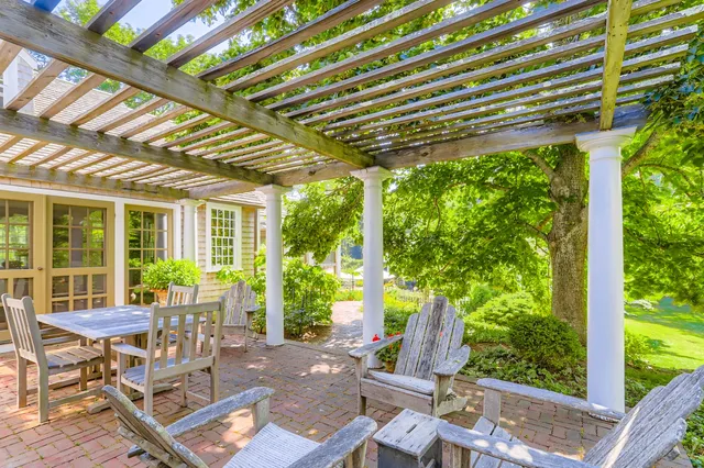 a living room with furniture a bookshelf and a window