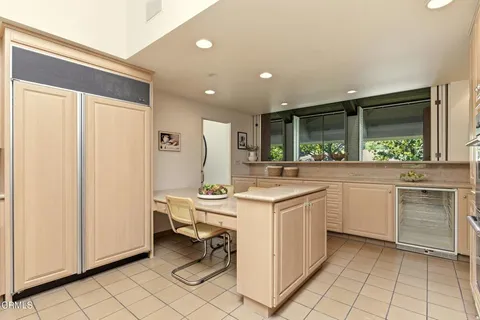 a kitchen with a stove and white cabinets