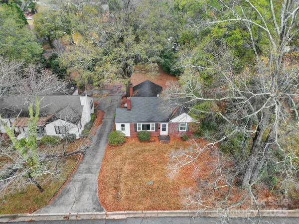 an aerial view of a house with a yard