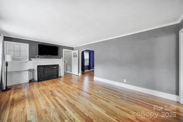 a view of a livingroom with an empty space and a fireplace