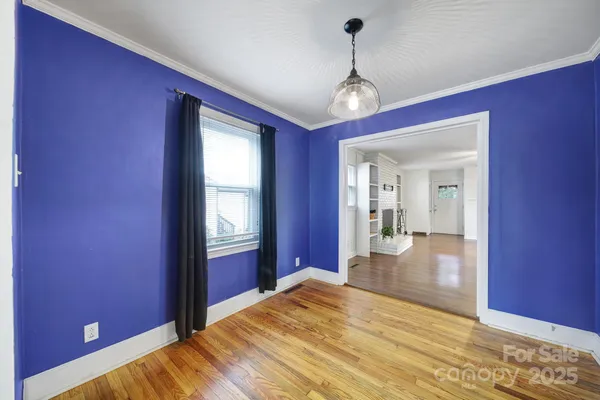 a view of a room with wooden floor and windows