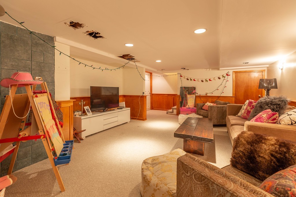 140 Whiting Street Hingham, MA 02043 - Photo 17 of 25 a living room with furniture and a flat screen tv