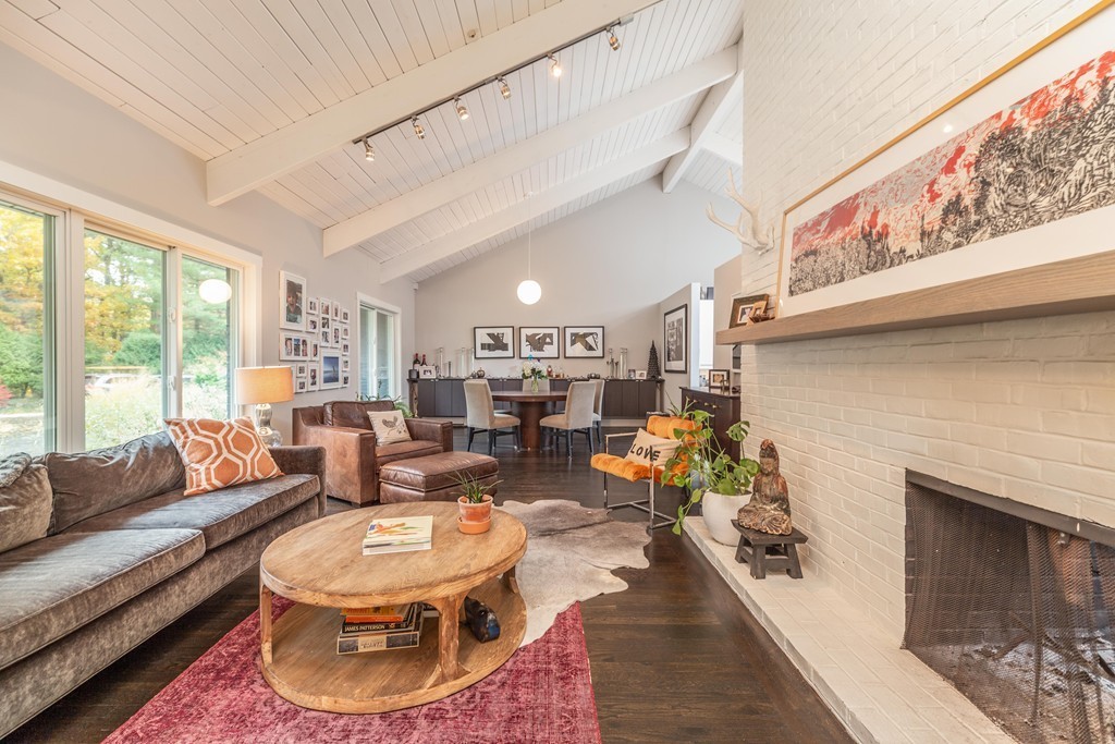 140 Whiting Street Hingham, MA 02043 - Photo 2 of 25 a living room with furniture a fireplace and a large window