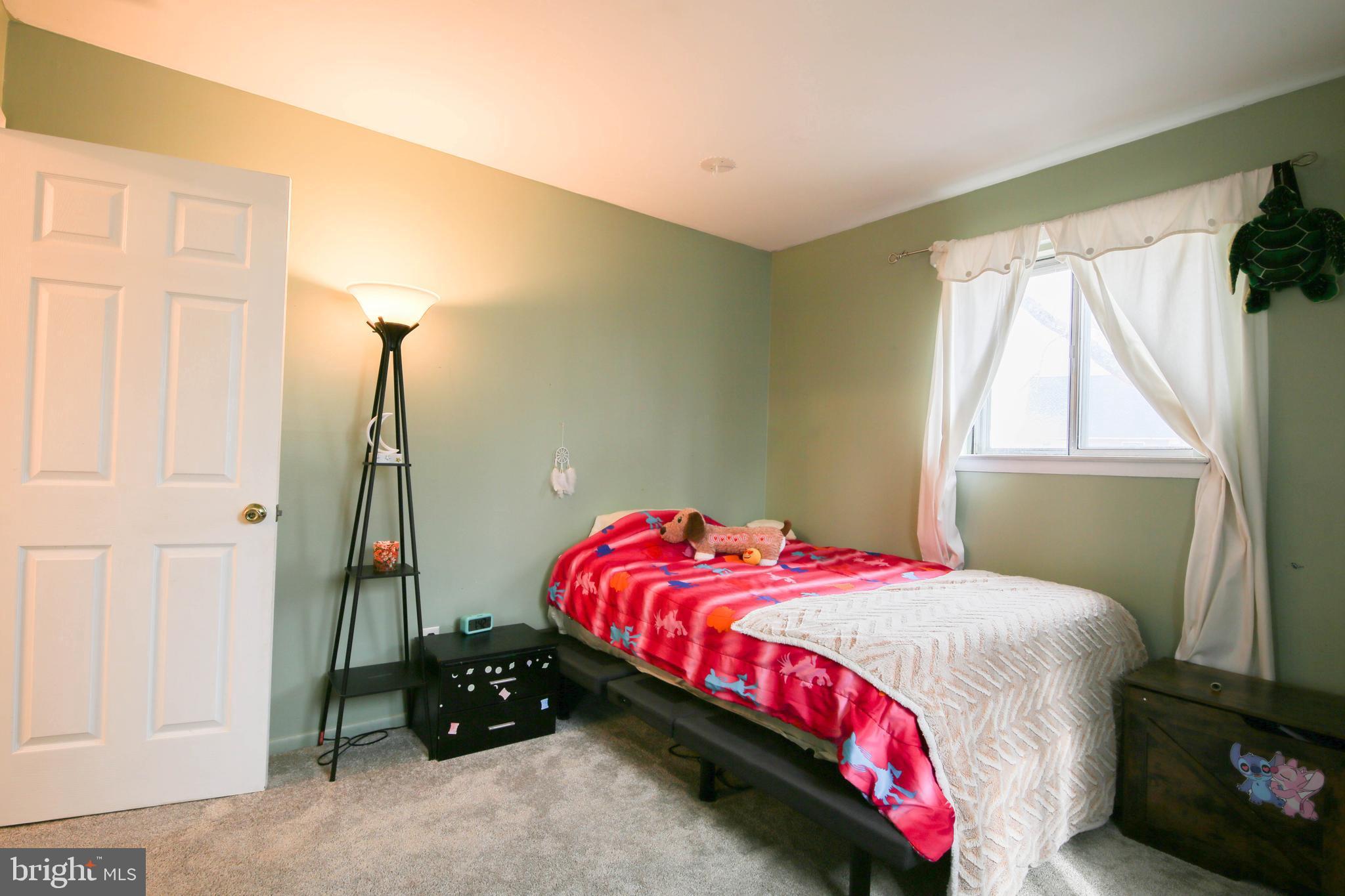 105 West Village Road Elkton, MD 21921 - Photo 11 of 32 a bedroom with a bed and a window