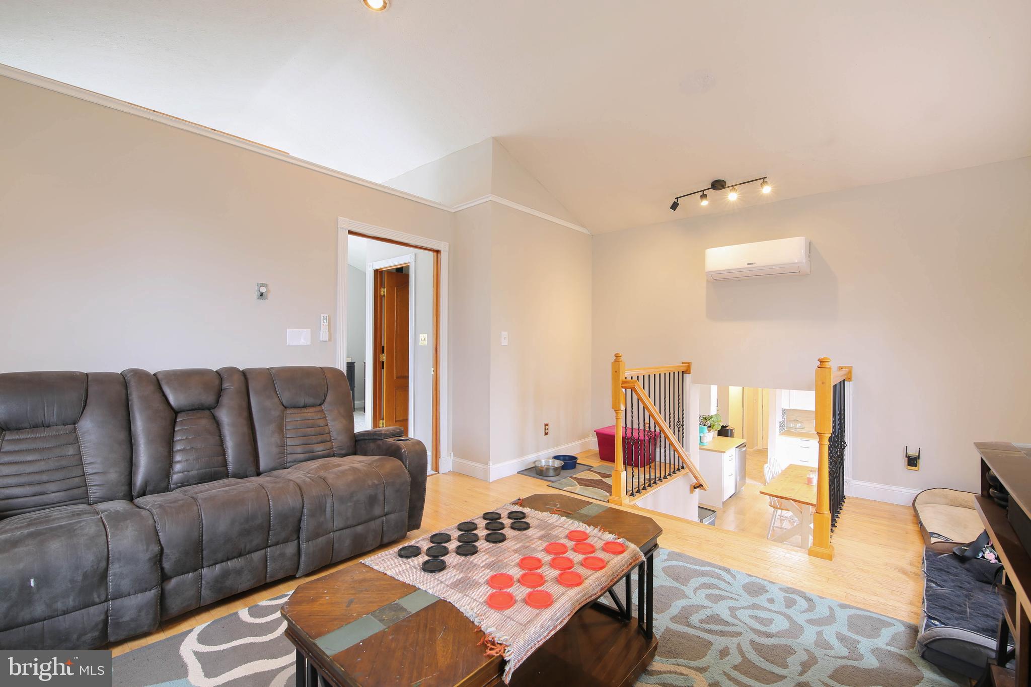 105 West Village Road Elkton, MD 21921 - Photo 16 of 32 a living room with furniture a rug and a wooden floor