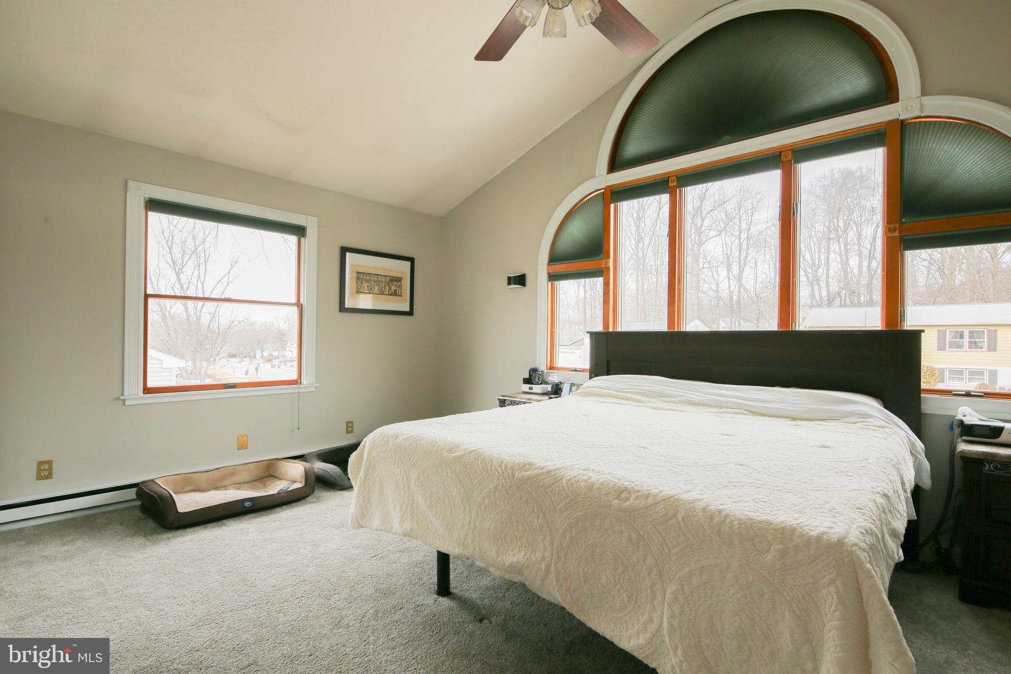 105 West Village Road Elkton, MD 21921 - Photo 17 of 32 a bedroom with a bed and a large window