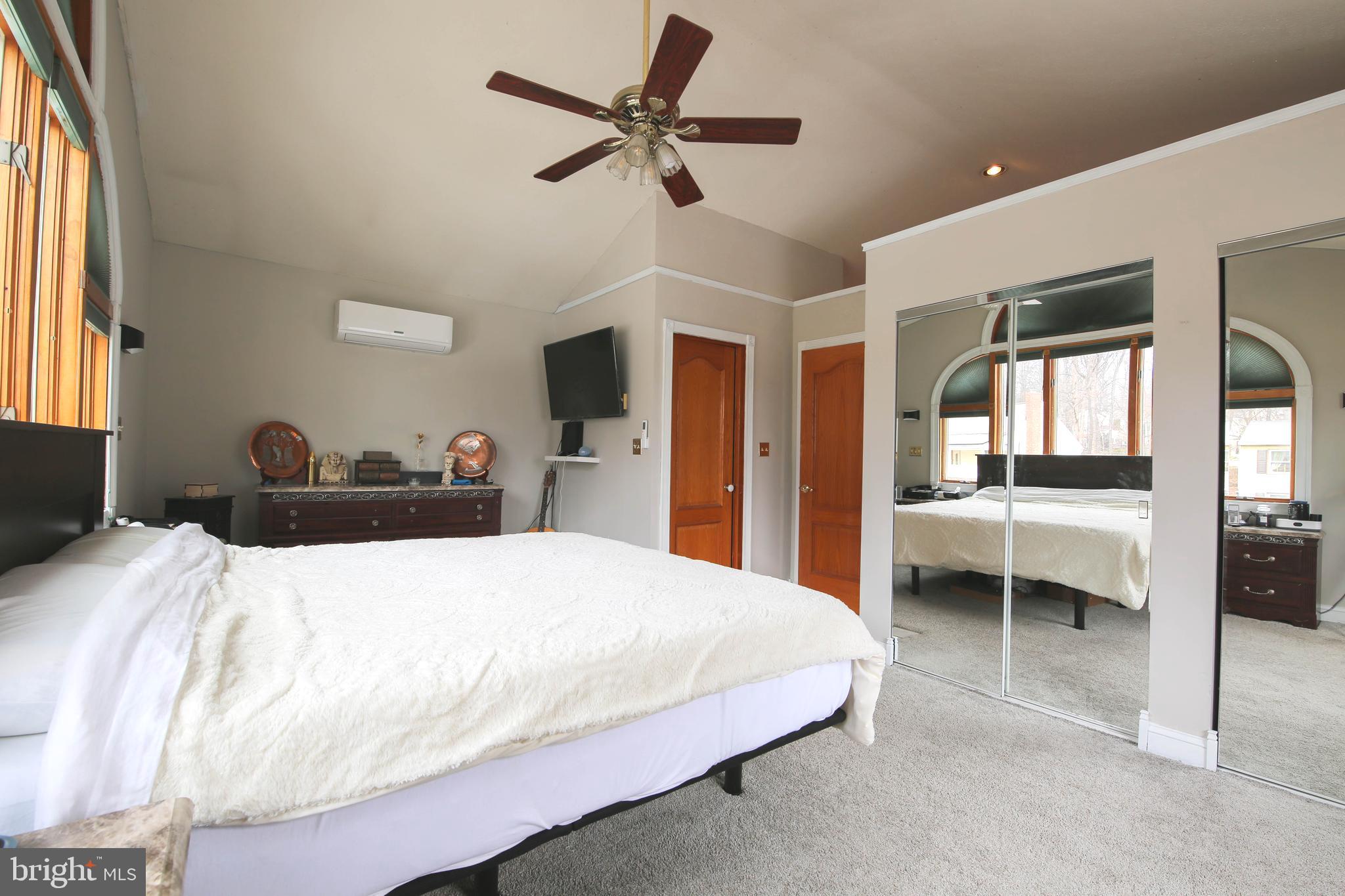 105 West Village Road Elkton, MD 21921 - Photo 18 of 32 a bedroom with a bed and a large mirror