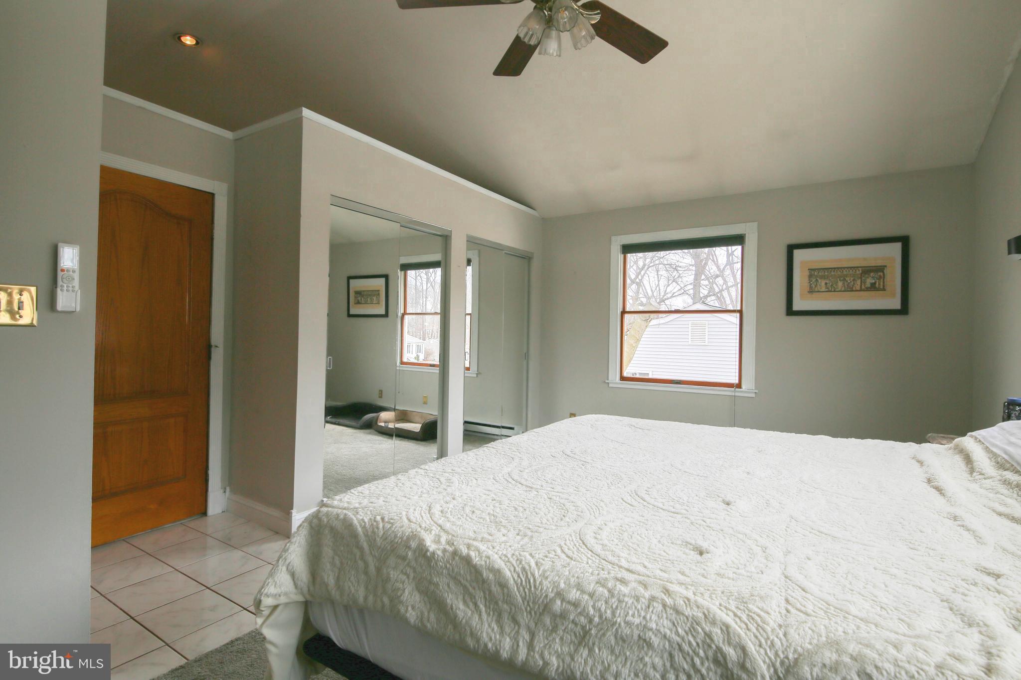 105 West Village Road Elkton, MD 21921 - Photo 19 of 32 a bedroom with a bed and a chandelier