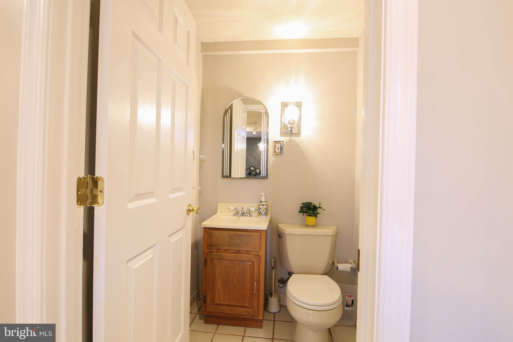 105 West Village Road Elkton, MD 21921 - Photo 26 of 32 a bathroom with a toilet a sink and mirror