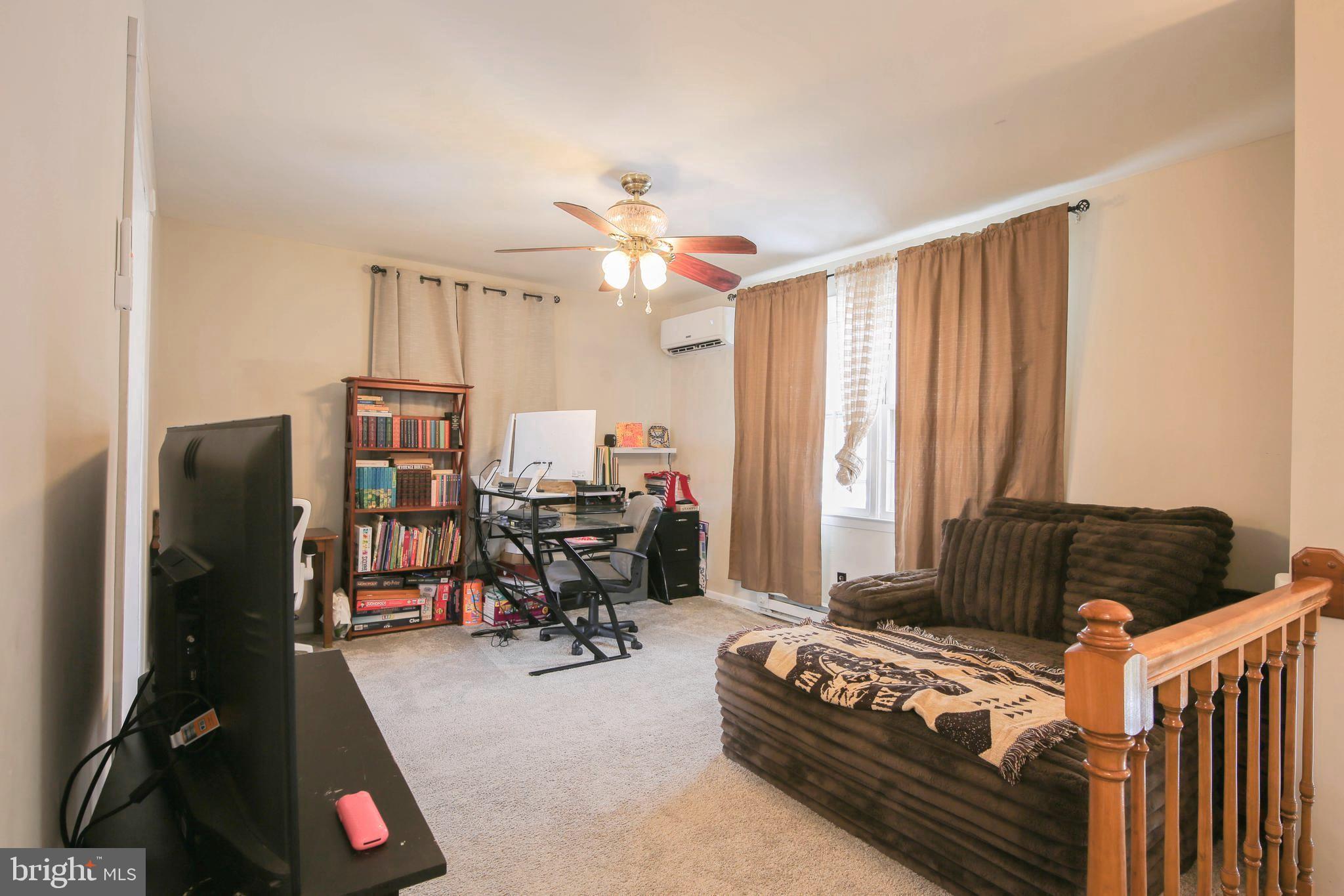 105 West Village Road Elkton, MD 21921 - Photo 3 of 32 a bedroom with furniture and a large window