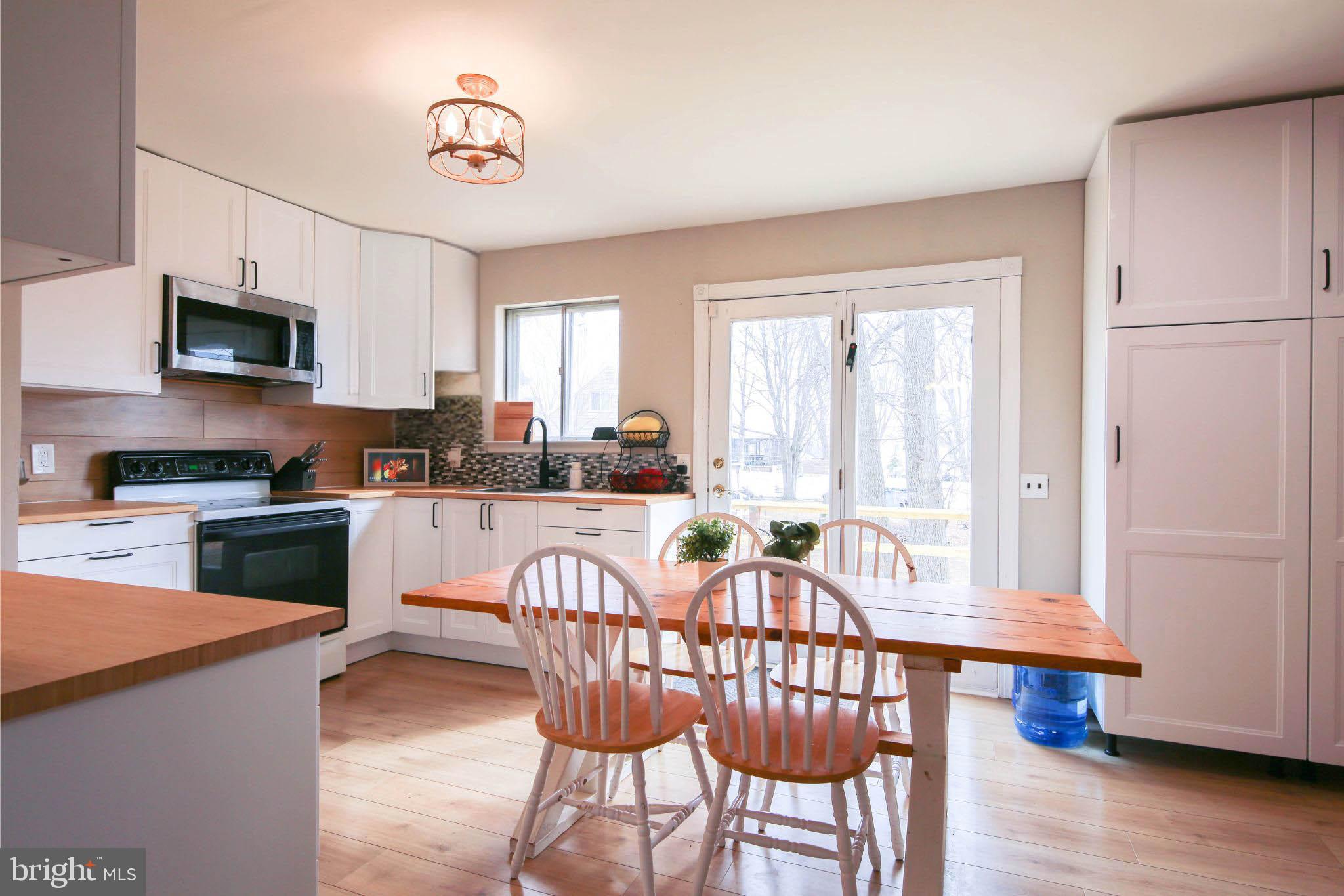 105 West Village Road Elkton, MD 21921 - Photo 6 of 32 a view of a dining room with furniture window and wooden floor