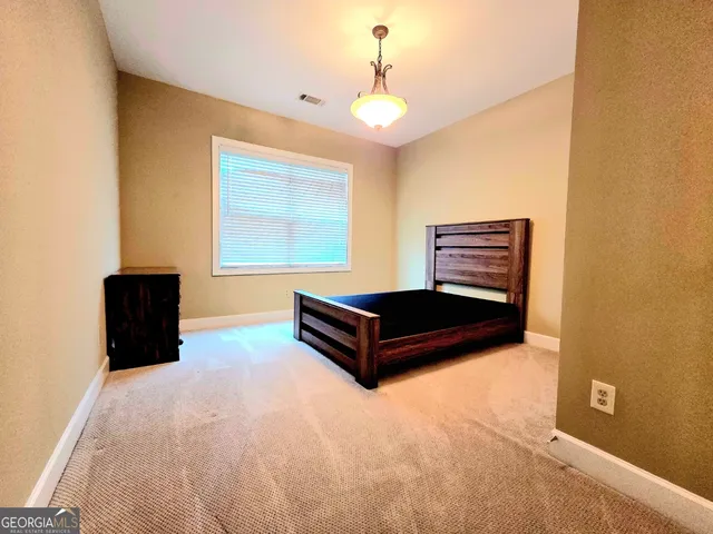 a living room with a bed and a chandelier