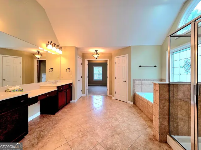 a large bathroom with a large tub and sink