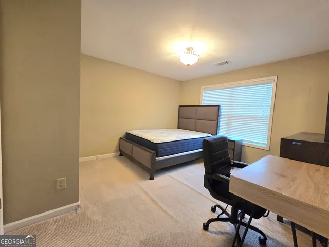 a bedroom with a bed and a desk