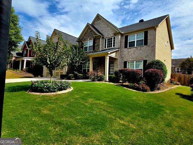 a front view of house with yard and green space