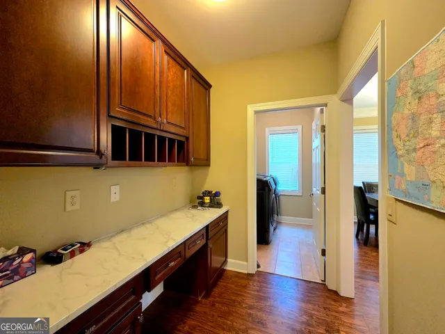 a room with wooden floor and furniture