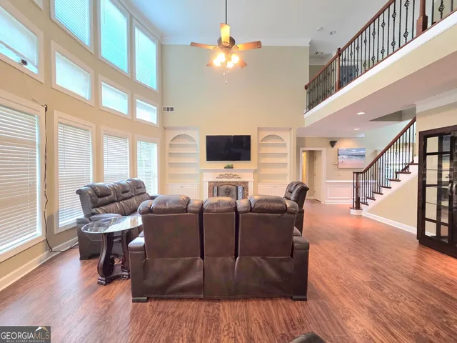 a living room with furniture a fireplace and a flat screen tv