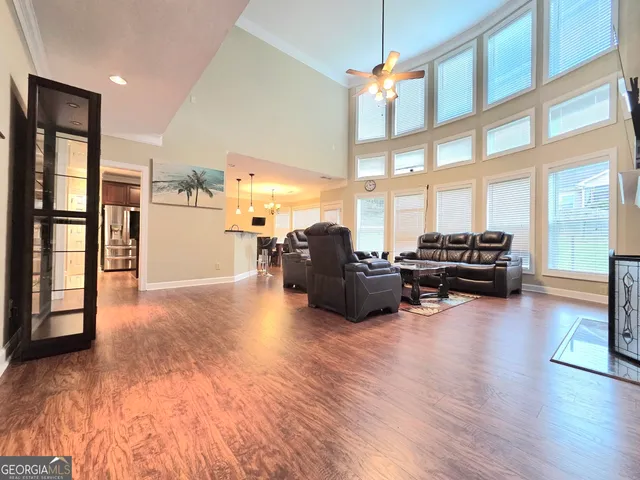 a living room with furniture window and wooden floor