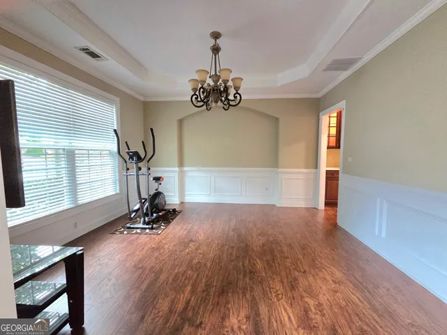 a view of a room with wooden floor and windows