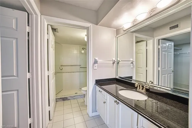 a bathroom with a granite countertop sink mirror and double