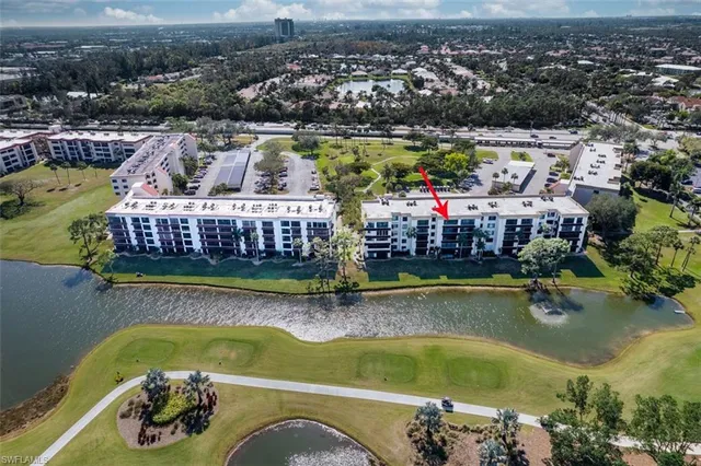 an aerial view of a house with swimming pool and lake view