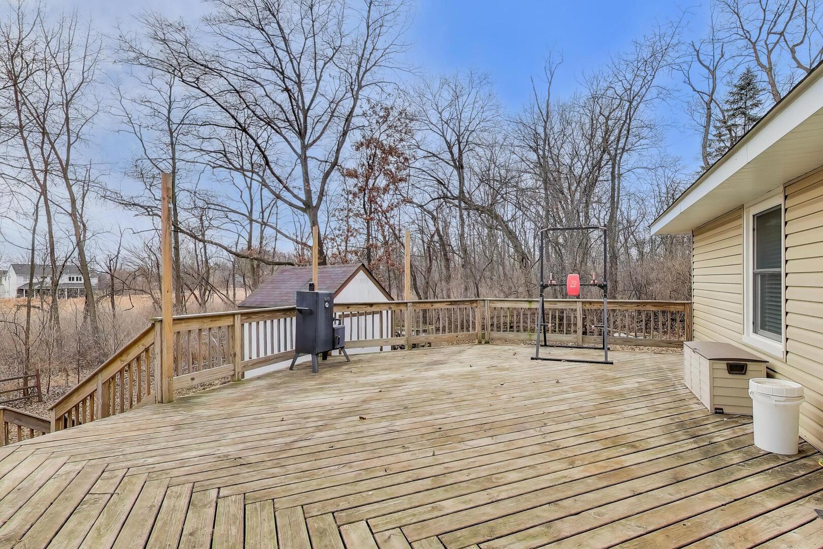 1127 Timber Trails Road Downers Grove, IL 60516 - Photo 24 of 30 a deck view with wooden floor and floor to ceiling window