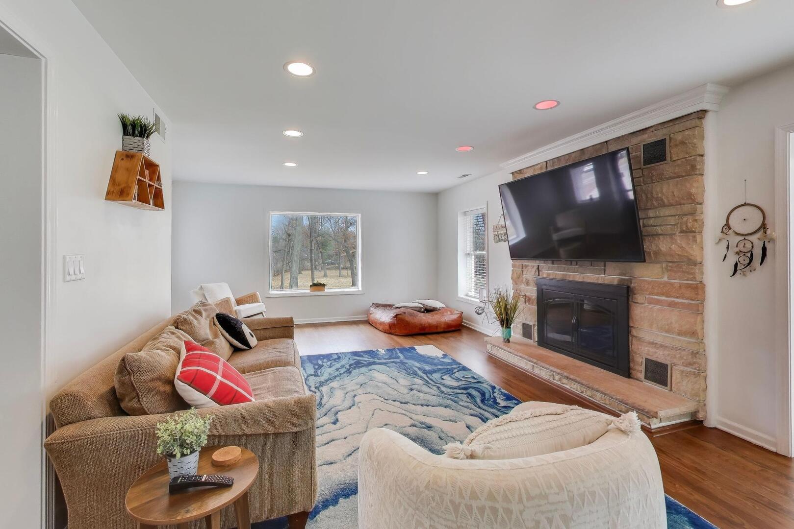 1127 Timber Trails Road Downers Grove, IL 60516 - Photo 7 of 30 a living room with furniture flat screen tv and a fireplace