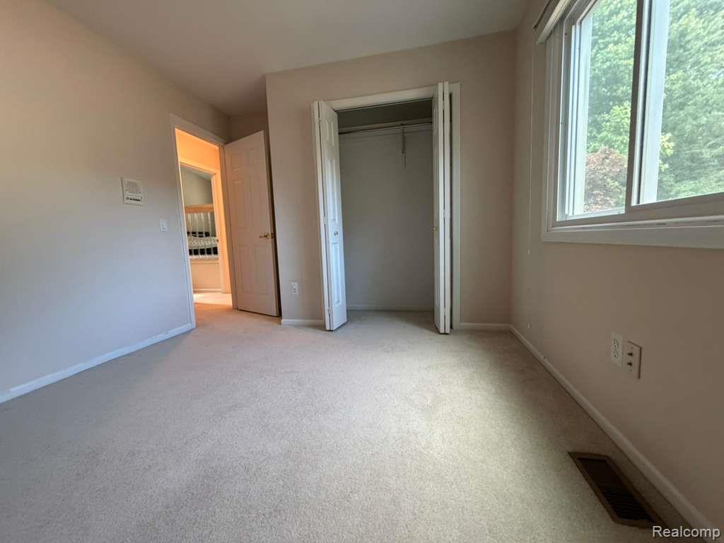 1154 Bluebird Drive Rochester, MI 48307 - Photo 21 of 34 Neutral tone wall paint complements the light-toned carpeting throughout this room