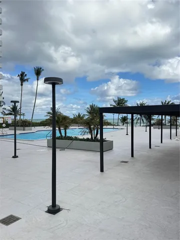 a view of a yard and ocean from a terrace