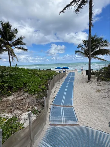 a view of a closet area with wooden floor