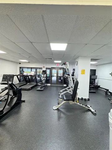 a small pool with lawn chairs and a yard