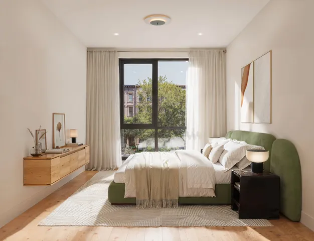 a bedroom with bed and glass window