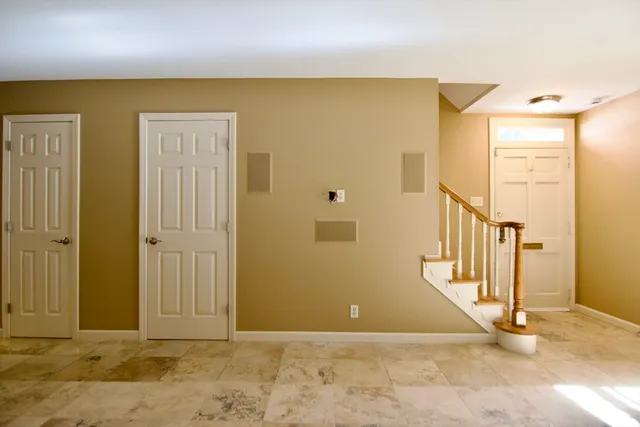 a view of a hallway with wooden floor and a bathroom